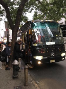 A Boulevard East jitney bus operated by Sphinx Transportation, loading on 42nd Street.