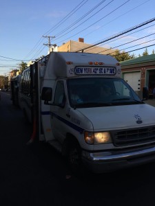 New York-bound jitney on Palisade Avenue. Signage indicates the New York dropoff location.